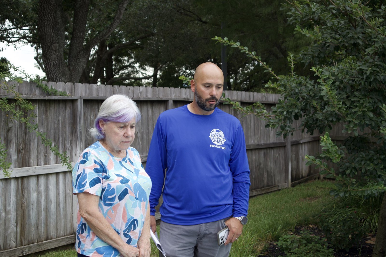 Xavier, the owner, walking a homeowner through her pool project