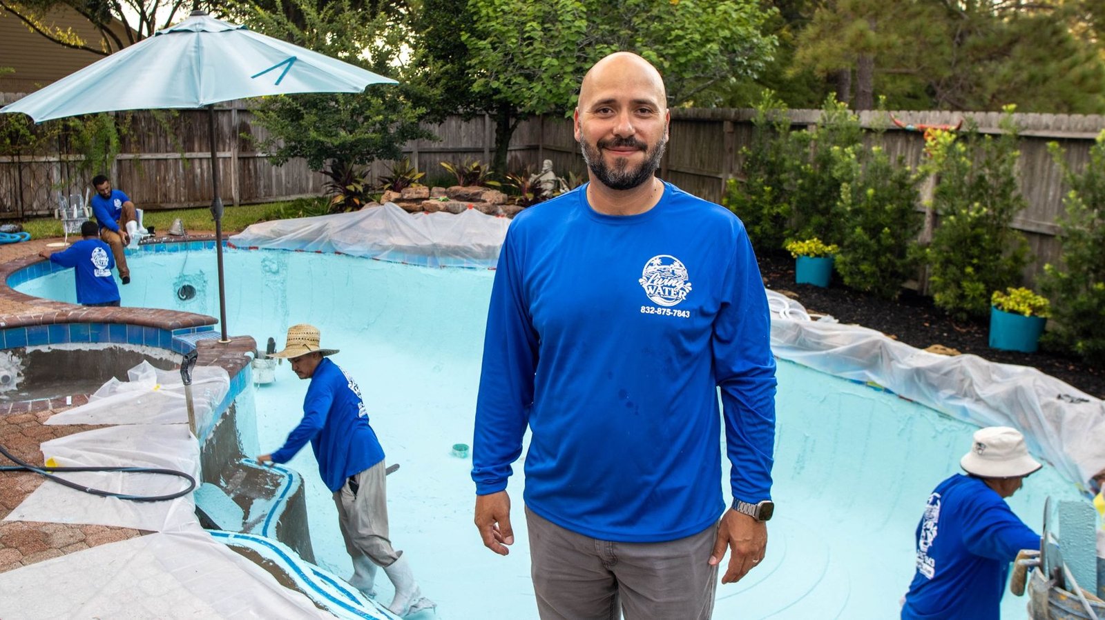 Xavier Alanis, owner of Living Water Pool Plastering, with his crew working behind him
